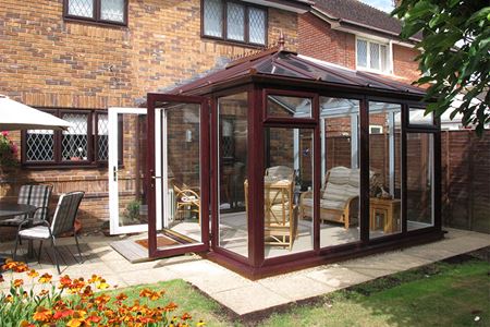 Dual Darkwoodgrain uPVC Elizabethan conservatory with French doors in open position