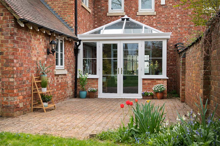White uPVC Elizabethan conservatory and French doors