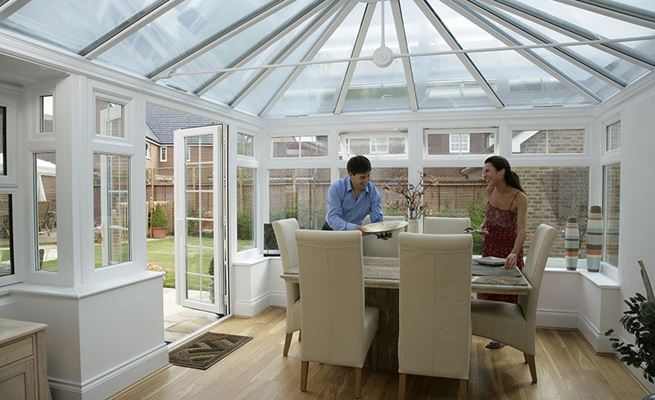 White UPVC Elizabethan conservatory dining room extension with Georgian bar French doors and UPVC casement windows