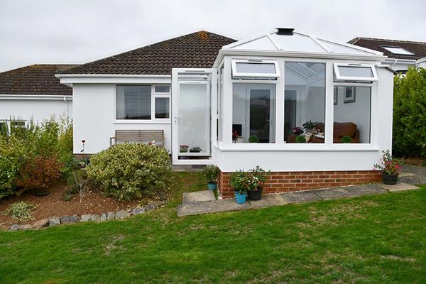White uPVC Elizabethan conservatory with French doors in open position