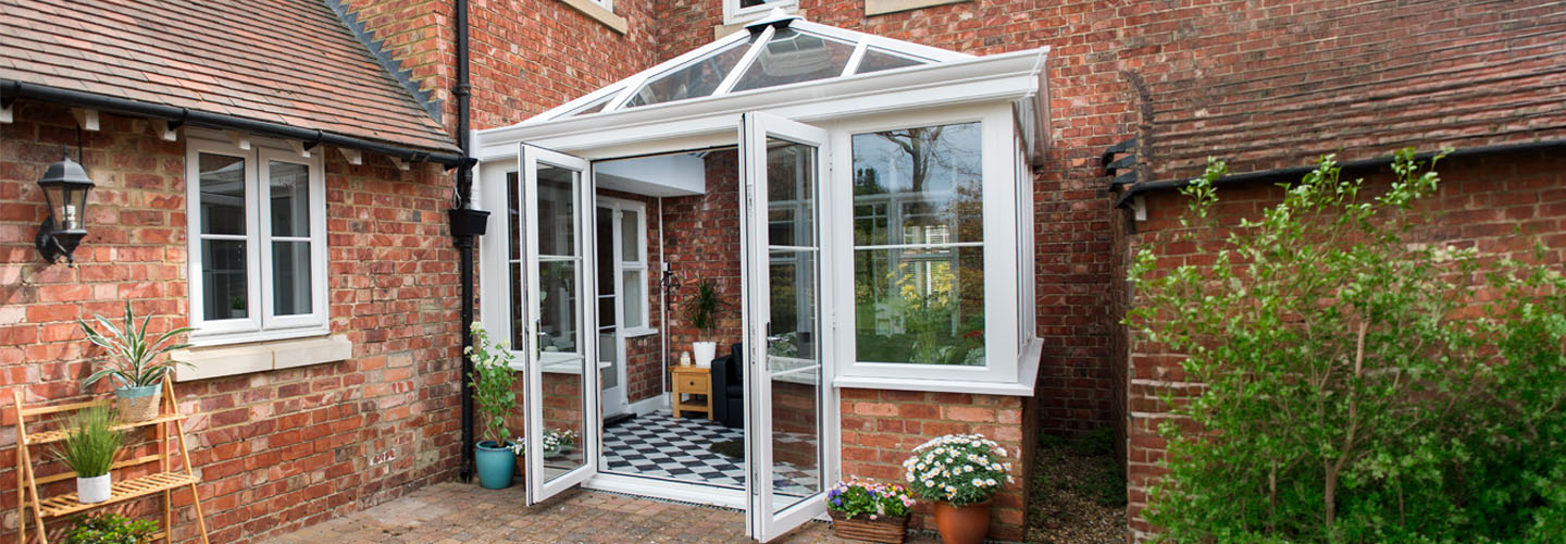 White uPVC Elizabethan conservatory with open doors banner