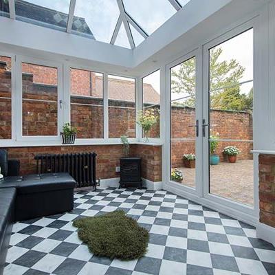 White uPVC Elizabethan conservatory with solar glass roof and Georgian bars interior
