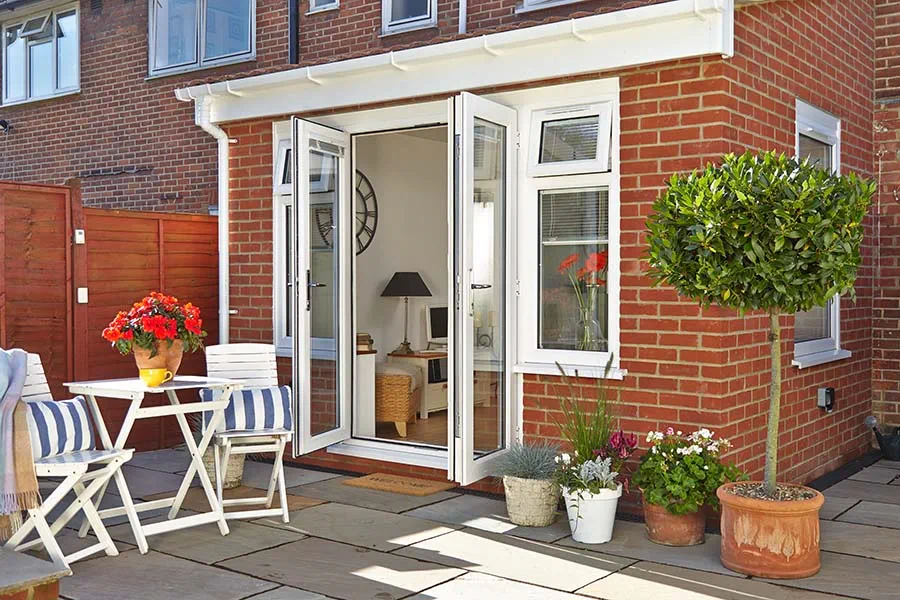 Solid tile roof extension with white uPVC French doors