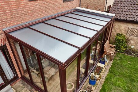 Dark woodgrain uPVC lean to conservatory with polycarbonate roof