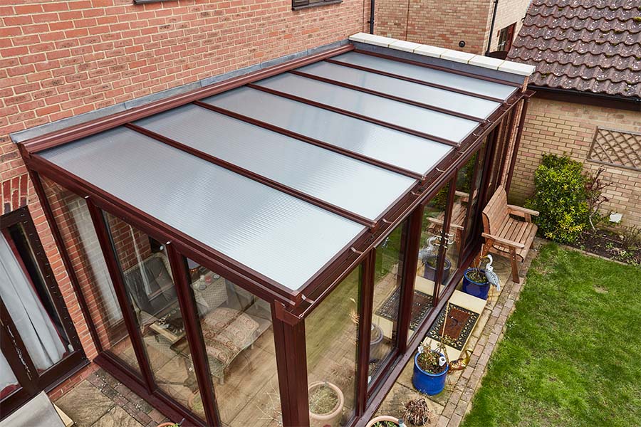 Dark woodgrain uPVC lean to conservatory with polycarbonate roof