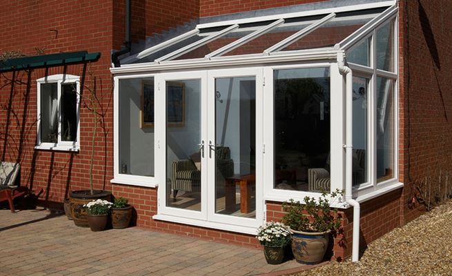 White UPVC garden room lean to conservatory with French doors and large casement windows from the Anglian classic conservatory range