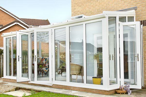 White UPVC lean to garden room conservatory with double French doors and large UPVC windows from Anglian Home Improvements