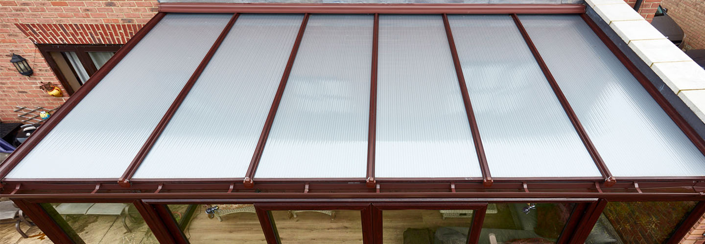 Dark woodgrain uPVC lean to with polycarbonate roof banner
