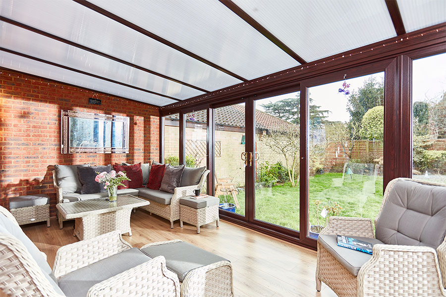 Dark woodgrain uPVC lean to with polycarbonate roof interior