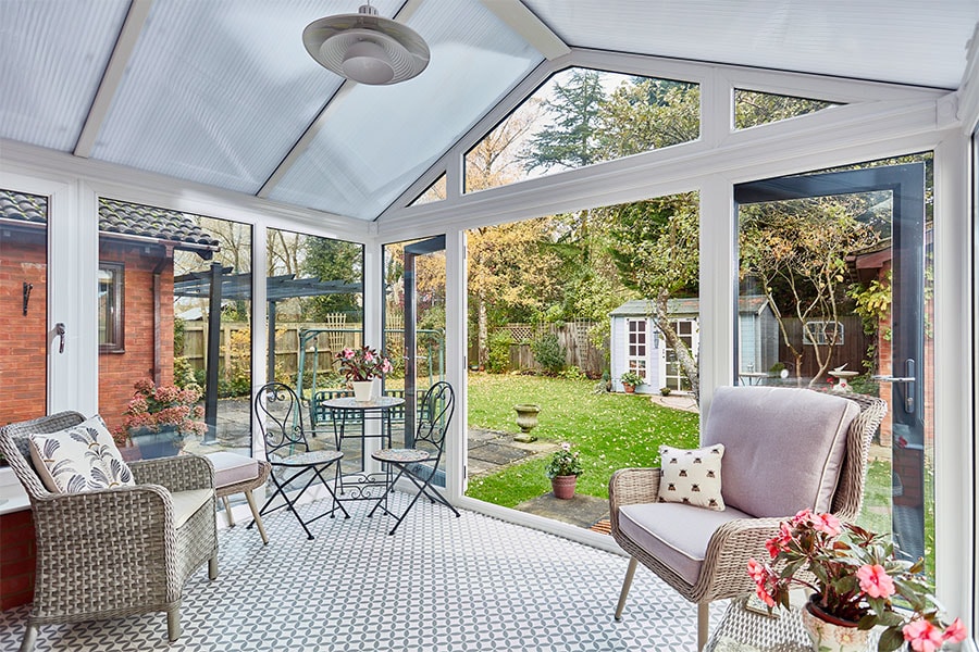 Dual anthracite grey Regency conservatory with polycarbonate roof and French doors in open position