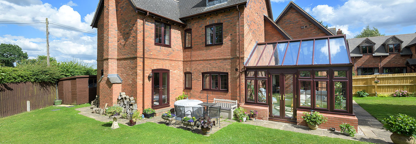 Dark woodgrain uPVC gable end Regency conservatory banner