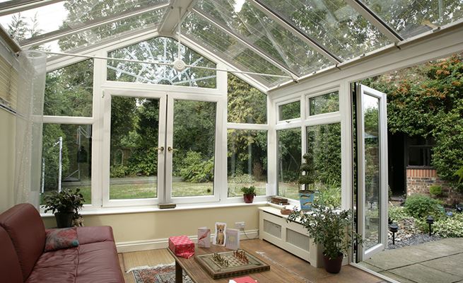 Regency conservatory in White uPVC with Sunburst glazing detail and French doors