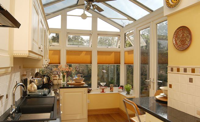 Regency conservatory kitchen extension in White UPVC with conservatory blinds and top hung casement windows