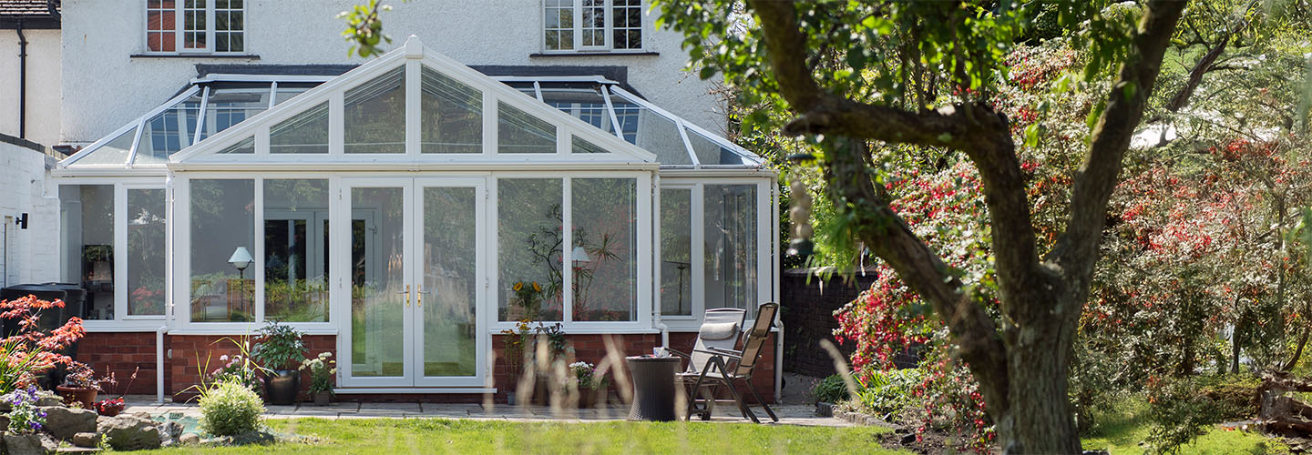 White uPVC Regency conservatory with French doors banner