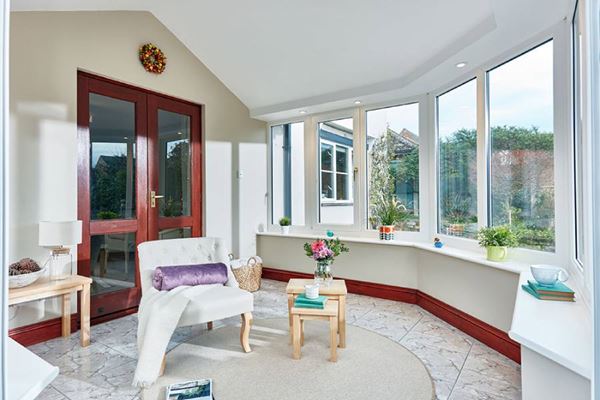 Interior view of solid roof conservatory with white UPVC casement windows from the Anglian solid roof conservatory range