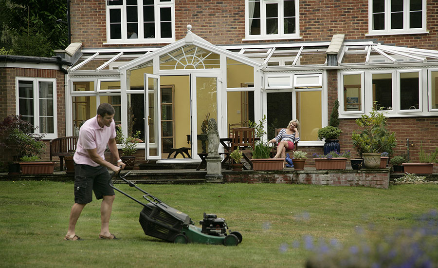 Garden view of t-shaped conservatory in white UPVC from the Anglian classic conservatory range