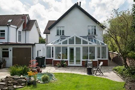 White uPVC T Shaped Harmony conservatory with French doors and tilt and turn windows