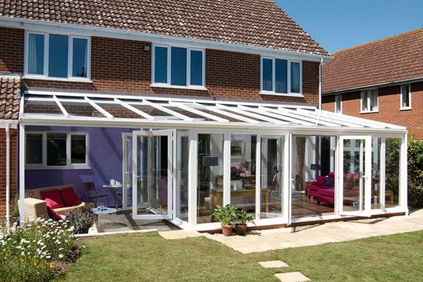 White UPVC Veranda conservatory finished with two sets of French doors and floor to ceiling casement windows from Anglian Home Improvements