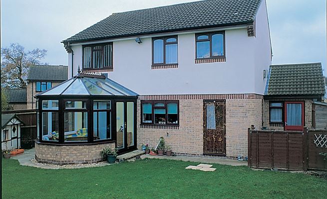 Dual Dark Brown and White UPVC Victorian conservatory with glass roof panels and French doors from the Anglian conservatory range