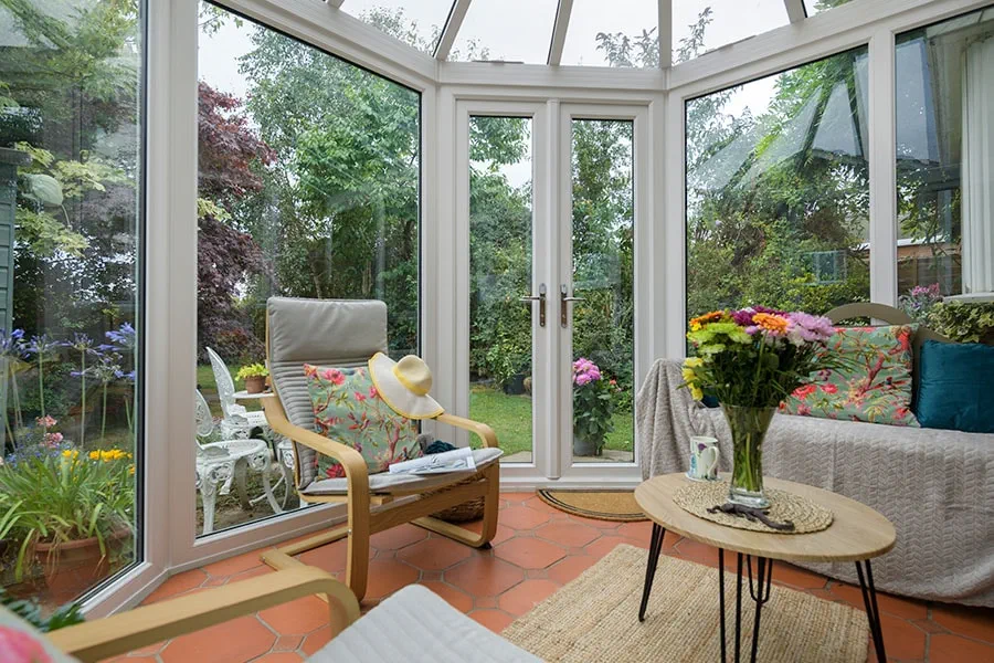 Dual sage green uPVC Victorian conservatory with French doors