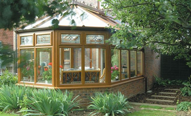 Golden Oak UPVC Victorian conservatory with top hung casement windows with Fusion decorative glass from Anglian Home Improvements