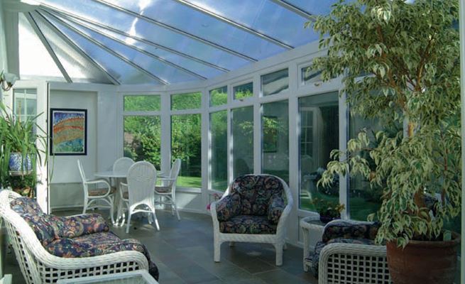 Large white UPVC conservatory with polycarb roof and top hung casement windows from the Anglian classic conservatory range
