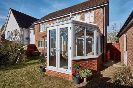 Small White uPVC Victorian conservatory with French doors