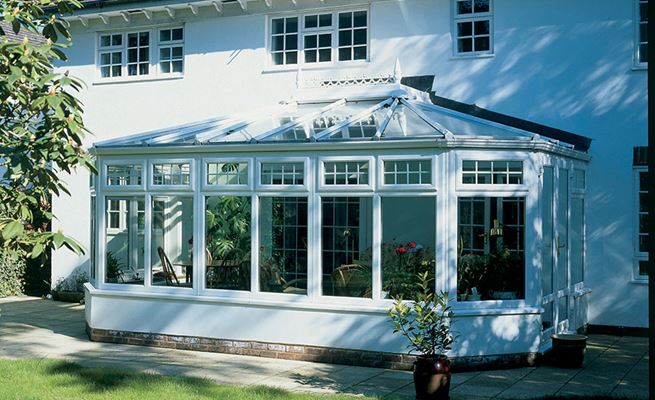White UPVC Victorian conservatory with top hung cottage bar casement windows and classic finial from Anglian Home Improvements
