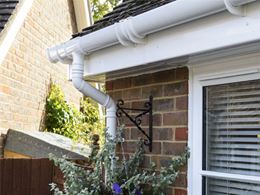 Close up of white UPVC downpipe guttering from Anglian Home Improvements