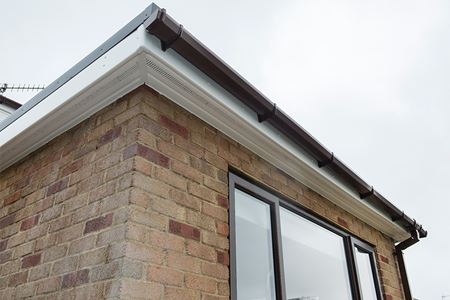 white uPVC soffits and fascias with black guttering and windows