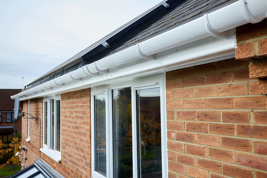 White uPVC half round guttering and uPVC windows