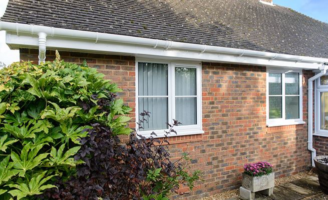 White uPVC guttering and downpipes on a bungalow from the Anglian guttering range