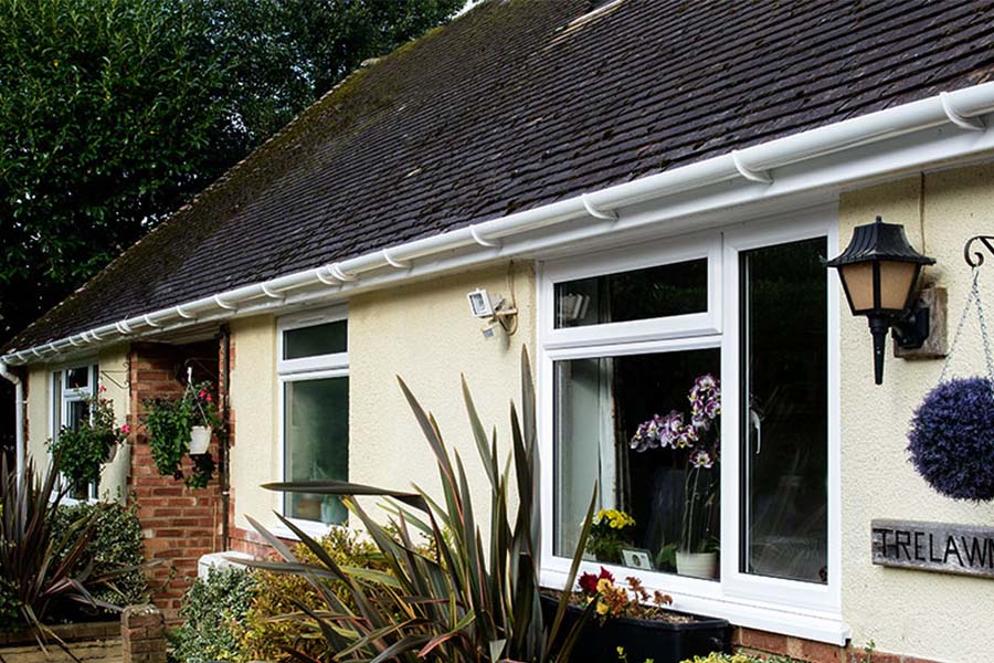 Front of house view of White uPVC guttering and downpipes on a bungalow from Anglian Home Improvements