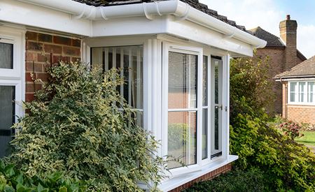White uPVC gutter and fascia above a bay window