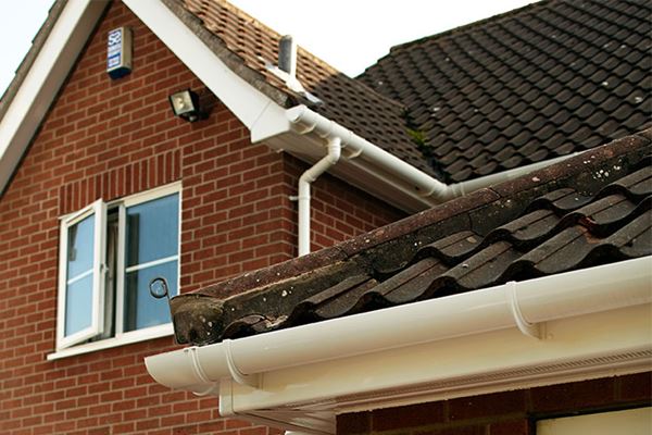 White uPVC guttering and downpipes and a gable end bargeboard from the Anglian rooftrim range