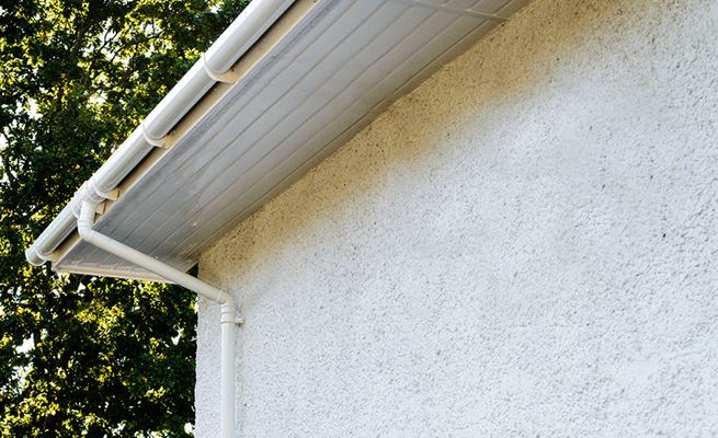 White uPVC soffits under guttering and downpipes from the Anglian soffit and fascia range