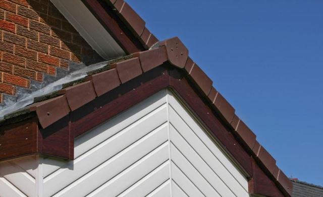 Anglian white shiplap cladding and brown uPVC bargeboard