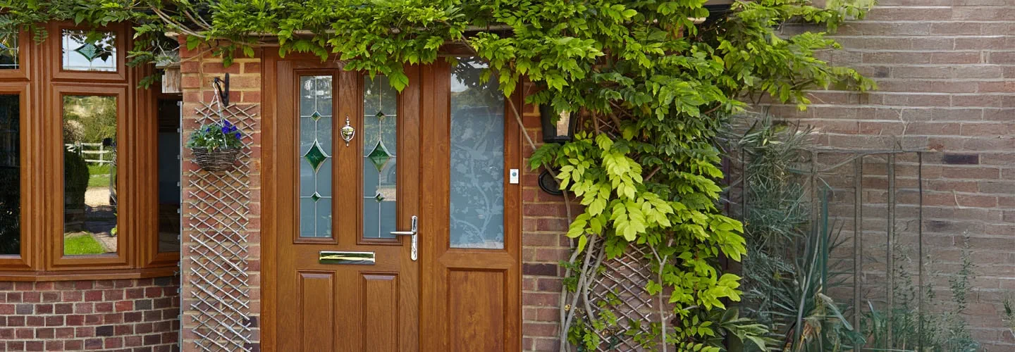 Golden oak uPVC front door with stained and etched glasss banner