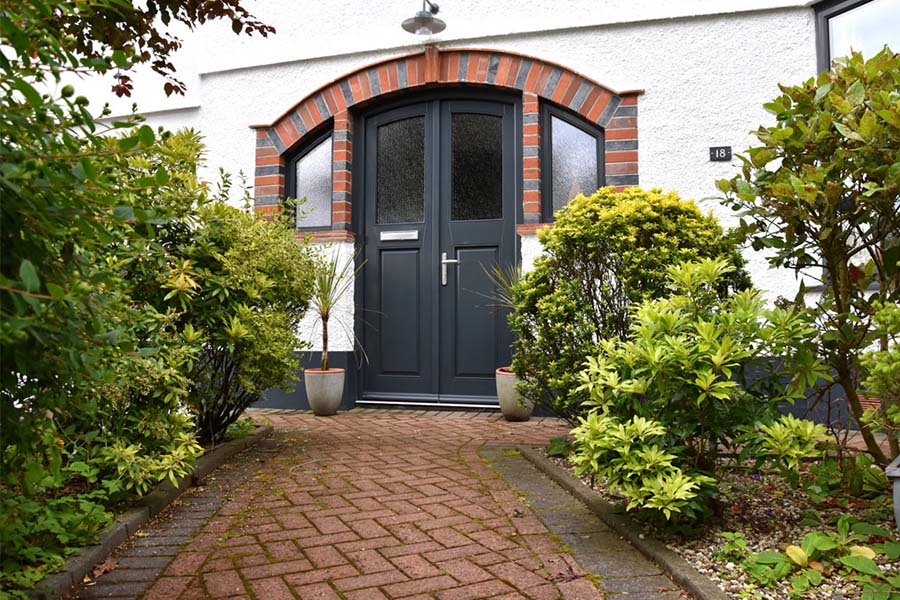 Grey double front door with two raked head side shaped windows from Anglian Home Improvements