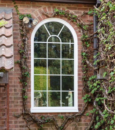 Arched head shaped window in white with Georgian bars