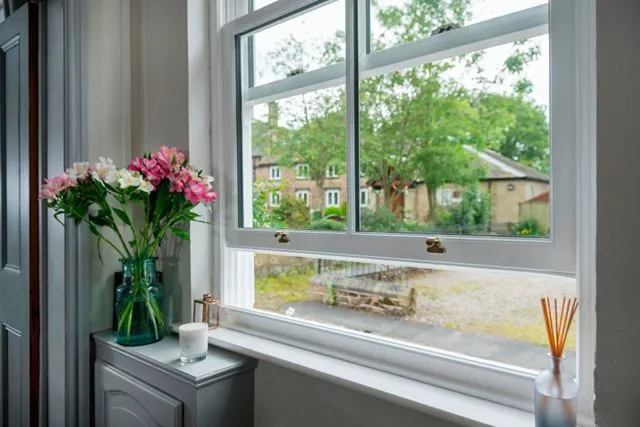 Open Victorian window with gold handles