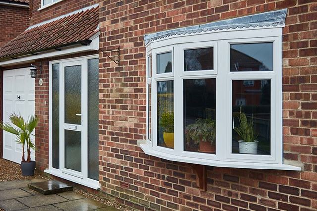 White aluminium bay windows with back door