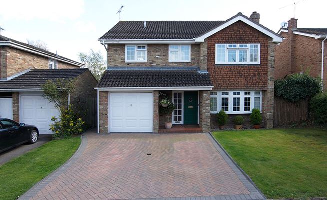 White uPVC bay window with Georgian bars on family home from the Anglian uPVC bay window range