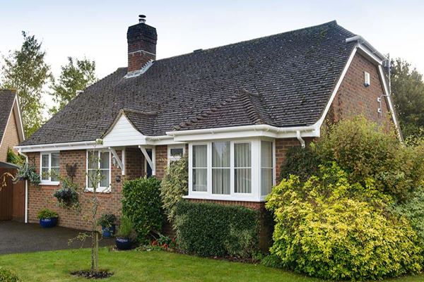 Bungalow with White UPVC bay casement window and roofline guttering and fascia from Anglian Home Improvements