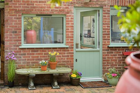 Sage green aluminium casement window and stable back door in open positionjpg