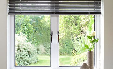 Internal view of garden through a white Aluminium window