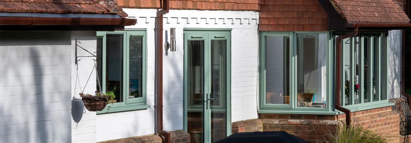 Sage green back door and uPVC casement windows banner