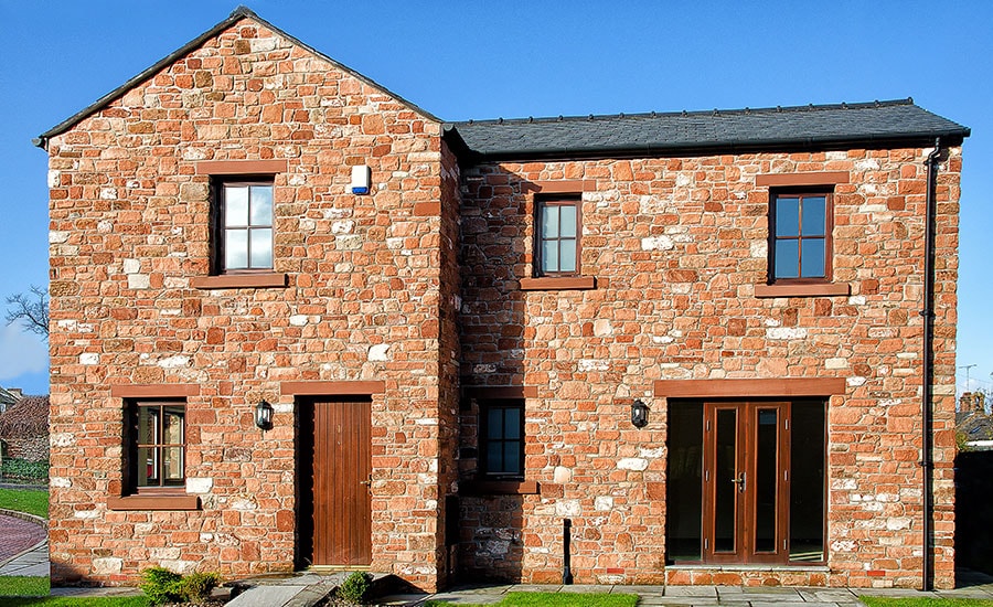 Whole house double glazed wooden windows and doors finished in Dark woodgrain from Anglian Home Improvements