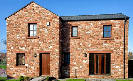 Detached property featuring timber windows & doors in dark woodgrain stain