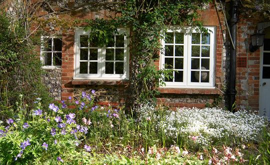 White timber casement windows with double glazing and cottage bars from the Anglian wooden windows range